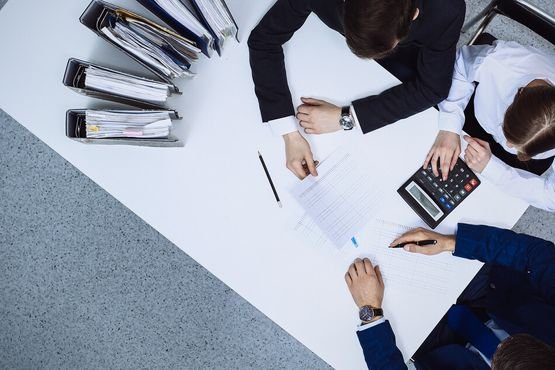 Business people at meeting, view from above. Bookkeeper or financial inspector making report, calculating or checking balance