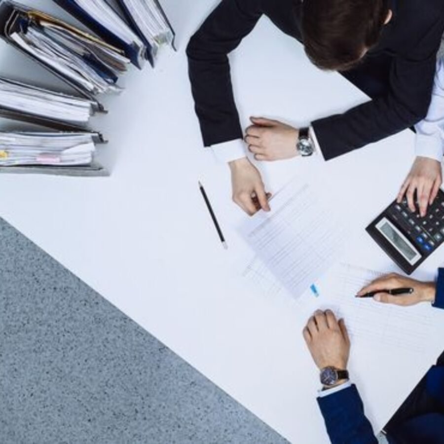 Business people at meeting, view from above. Bookkeeper or financial inspector making report, calculating or checking balance